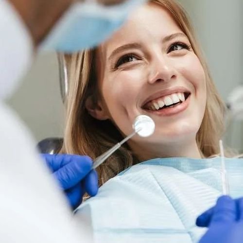 woman smiling in dentist exam chair | dentist dedham ma